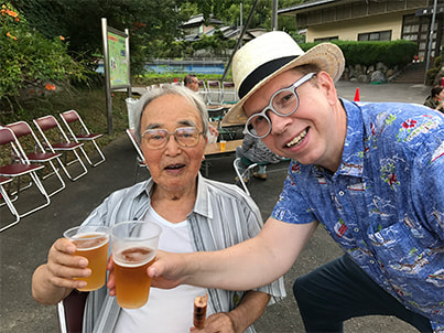 Hans Karlsson toasts with a participant in the Suwa festival in Tajimi, Gifu, Japan